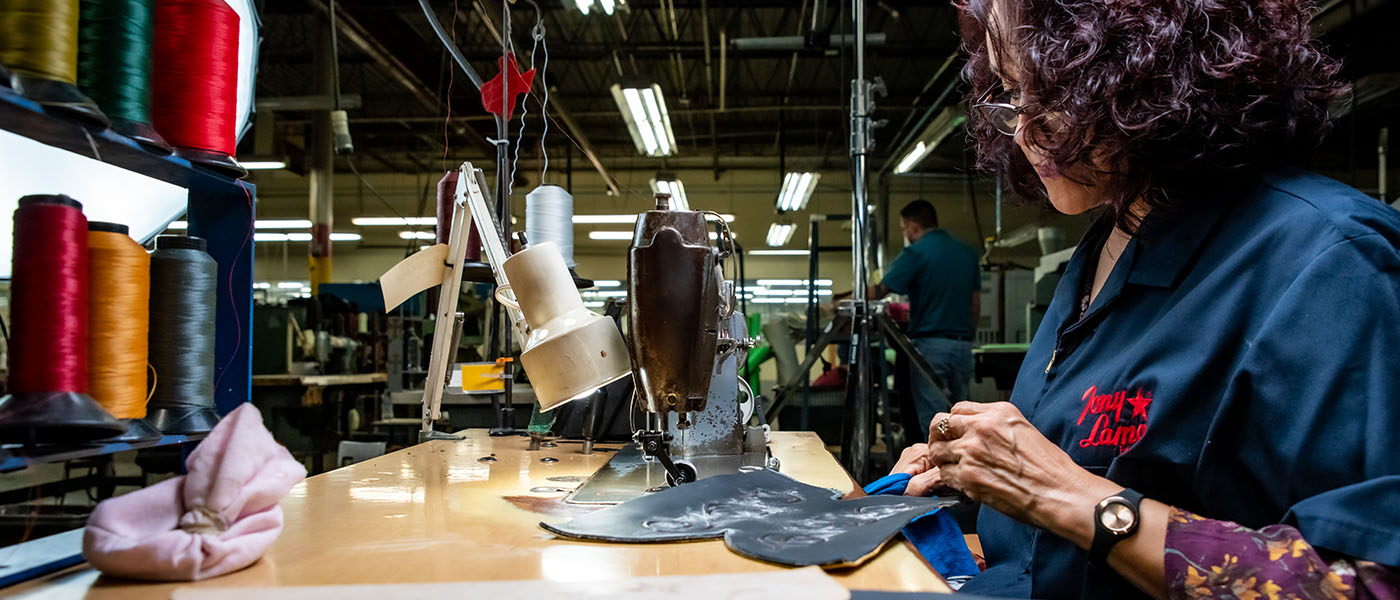 Women sews leather 